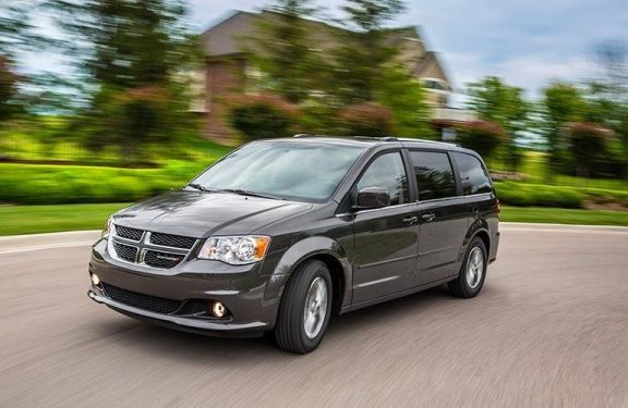 A 2017 Dodge Caravan speeding on a road